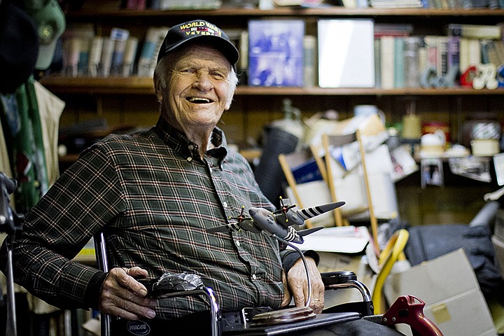 Former Army Air Force Capt. Ralph Miller, 93, is seen in his home in this 2012 file photo with a model of a Martin B-26B Marauder "Flack Bait," which he piloted during World War II. File photo by Adam Sacasa