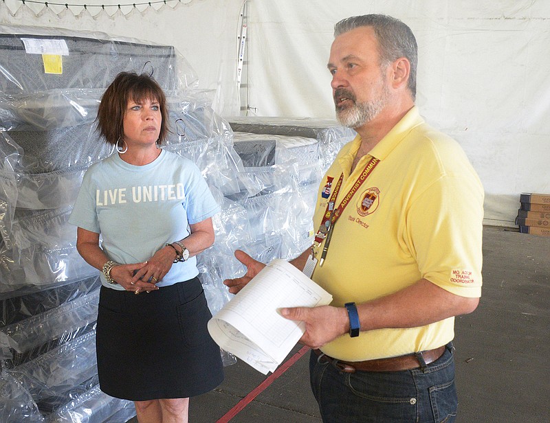 Ann Bax and Jody Dickhaut discuss the challenges of getting people to come out to pick up donated items Thursday at Capital West Christian Church.