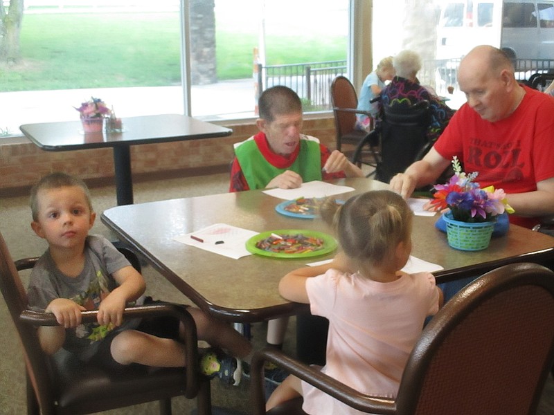 Children visiting from St. Paul's Daycare and residents at California Care Center enjoyed story time and coloring June 6, 2019, at their monthly day of fun.
