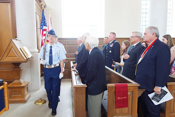 Thomas Klenke, left, of the Civil Air Patrol leads a color guard in front of veterans — including Richard Toshio Henmi, front row, foreground, and National Churchill Museum dignitaries. The museum hosted a ceremony Thursday to recognize the anniversary of D-Day.