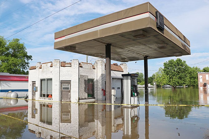 Caution tape surrounds the single gas station in Mokane. Mokane residents said the gas pumps were completely submerged during the Flood of 1993.