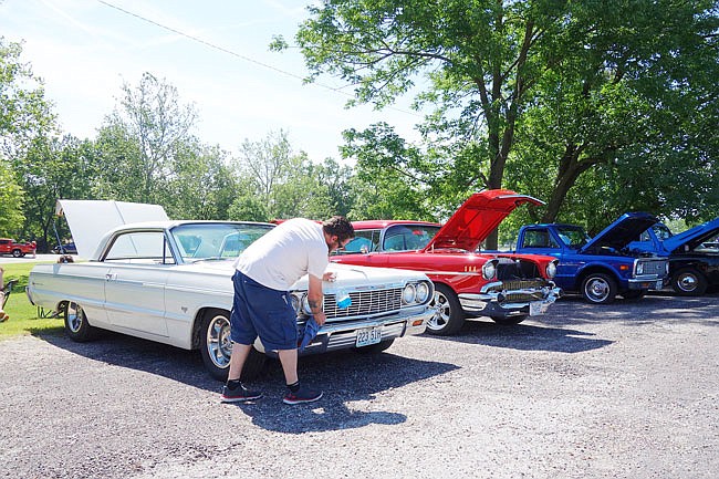 Lance Loyd, of Millersburg, puts a finishing shine on his 1964 Chevy Impala Super Sport. His family attends Drive to Survive each year, he said.