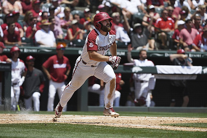 Arkansas batter Trevor Ezell reacts after hitting a home run against Mississippi in the sixth inning of Game 1 at the NCAA college baseball super regional tournament Saturday, June 8, 2019, in Fayetteville, Ark. (AP Photo/Michael Woods)