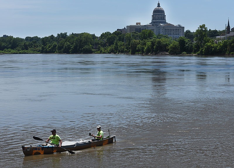 In this July 25, 2018 photo, Drake and Mark White paddle onto the shore of the Missouri River at the Noren River Access in Jefferson City during the MR340.