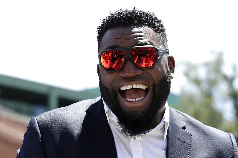 In this June 22, 2017, file photo, retired Boston Red Sox designated hitter David Ortiz, smiles outside Fenway Park in Boston. Ortiz returned to Boston for medical care after being shot in a bar Sunday, June 9, 2019, in his native Dominican Republic. 