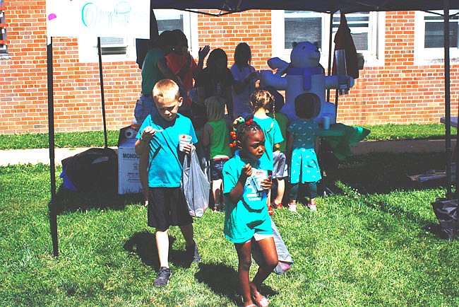 First-year campers provide snow cones for the children at their booth. This booth was one of 20 run by the MASC campers at William Woods University.
