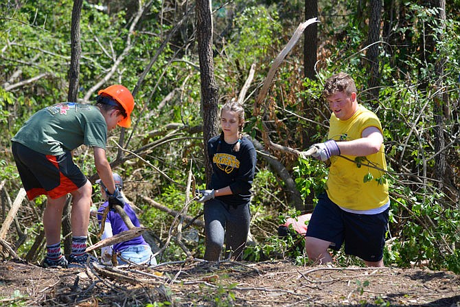 Volunteers helped remove remaining debris June 11, 2019, from behind Community Christian Church on Ellis Boulevard. This was the second day various organizations assisted the church with clearing trees and removing forestry from its outdoor sanctuary, which was damaged in the May 22 tornado.