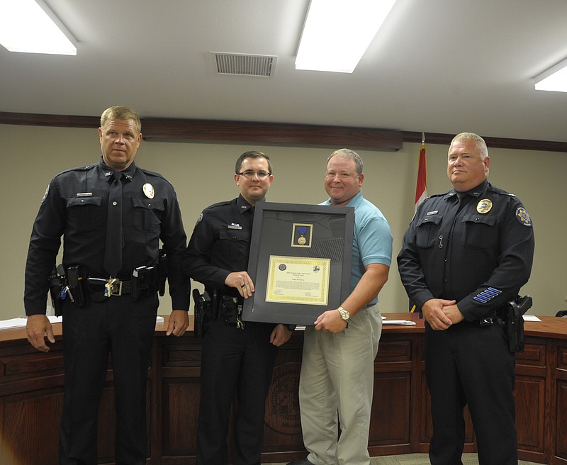 <p>News Tribune/Danisha Hogue</p><p>Officer Coltin McGowan received the first Metal of Valor in Holts Summit during Tuesday night’s board of aldermen meeting.</p>