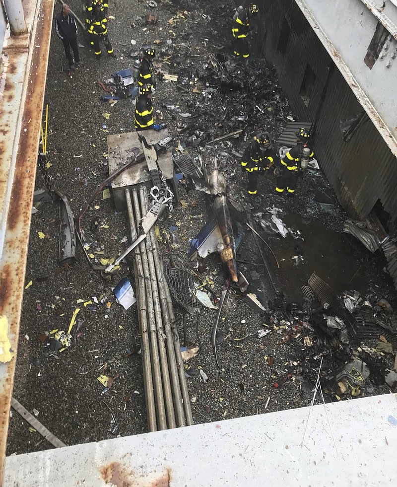 This photo released by the New York City Fire Department shows damage caused by a helicopter crash, south of Central Park in New York on Monday, June 10, 2019. The crash that killed the pilot and occurred near Times Square and Trump Tower shook the 750-foot (229-meter) AXA Equitable building sparked a fire and forced office workers to flee on elevators and down stairs, witnesses and officials said. (FDNY via AP)