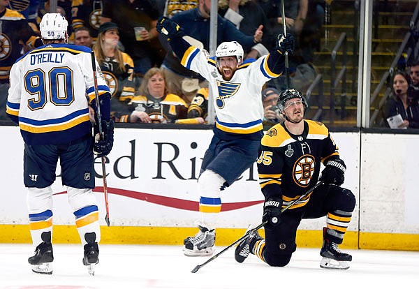 David Perron (center) of the Blues celebrates his goal behind Noel Acciari (right) of the Bruins last Thursday during the third period in Game 5 of the Stanley Cup Final in Boston.