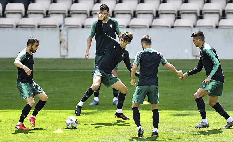 Portugal's Joao Felix, center, exercises with the team during a training session at the Bessa stadium in Porto, Portugal, Saturday, June 8, 2019. Portugal will play Netherlands in the UEFA Nations League final soccer match on Sunday. (AP Photo/Martin Meissner)