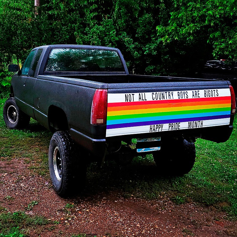 This Thursday, June 6, 2019, photo provided by Cody Barlow in Hulbert, Okla., shows self-described "straight, country boy" Cody Barlow's pickup truck decorated to show support for his LGBTQ loved ones for pride month. Barlow believes duct tape really can fix anything, including bigots. (Cody Barlow via AP)