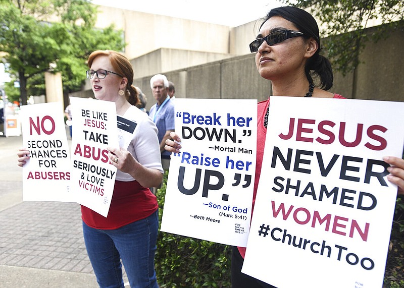 Jennifer Weed, left, and Nisha Virani, both of Birmingham, Ala., demonstrate outside Southern Baptist Convention's annual meeting Tuesday, June 11, 2019, during a rally in Birmingham, Ala. The For Such A Time As This protest calls for a change in the way the SBC views and treats women and demands action to combat sexual abuse within the establishment. 