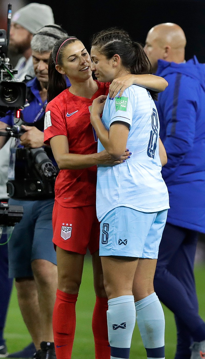 United States' Alex Morgan, left, comforts Thailand's Miranda Nild, right, after the Women's World Cup Group F soccer match between United States and Thailand at the Stade Auguste-Delaune in Reims, France, Tuesday, June 11, 2019. Morgan scored five goals during the match. (AP Photo/Alessandra Tarantino)