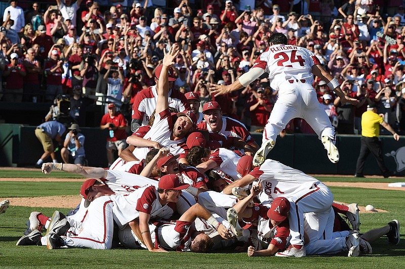 Arkansas players celebrate their 14-1 win over Mississippi after Game 3 at the NCAA college baseball super regional tournament Monday, June 10, 2019, in Fayetteville, Ark. (AP Photo/Michael Woods)