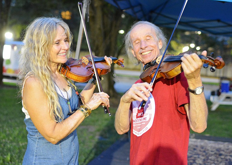 Jane Accurso and Dierik Leonhard, members of Swampweed Cajun Dancehall Band from Columbia, play a fiddle duet in August 2018, during the Backyard Concert Series at Jefferson Landing Historic Site in Jefferson City.