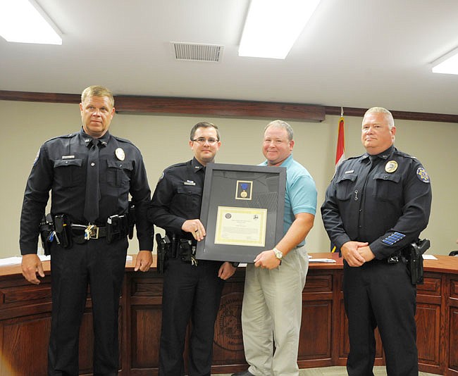 Holts Summit police officer Coltin McGowan received the first Medal of Valor in Holts Summit during Tuesday night's board of aldermen meeting.