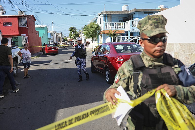 Authorities cordon off the area where journalist Marcos Miranda was kidnapped, in Boca del Rio, Veracruz state, Mexico, Wednesday, June 12, 2019. Miranda was abducted this morning from his home by armed men, according to the Network of Veracruz Journalists. (AP Photo/Felix Marquez)