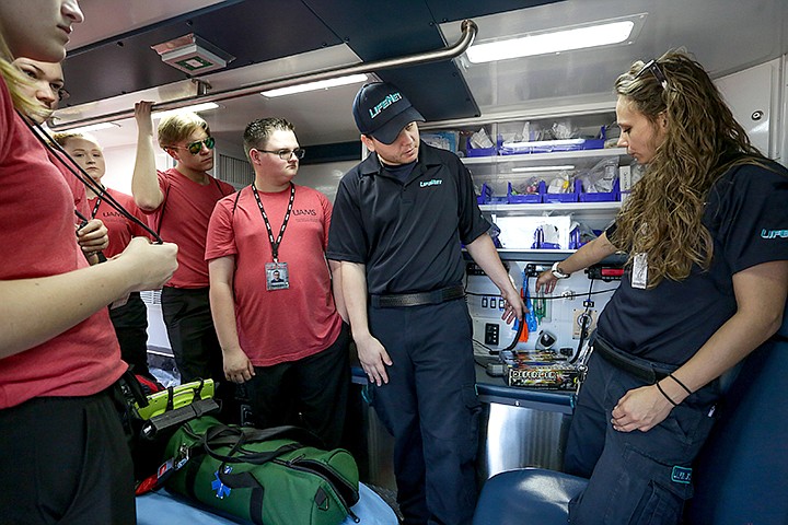 LifeNet EMTs Skylar Mitchell and Odie Moore explain the pieces of equipment in the back of a LifeNet ambulance to students in the MASH program on Thursday in Texarkana, Ark. Students that day performed a mock injury to demonstrate how ground crews respond to a patient that needed to be airlifted to a hospital. Staff photo by Hunt Mercier 