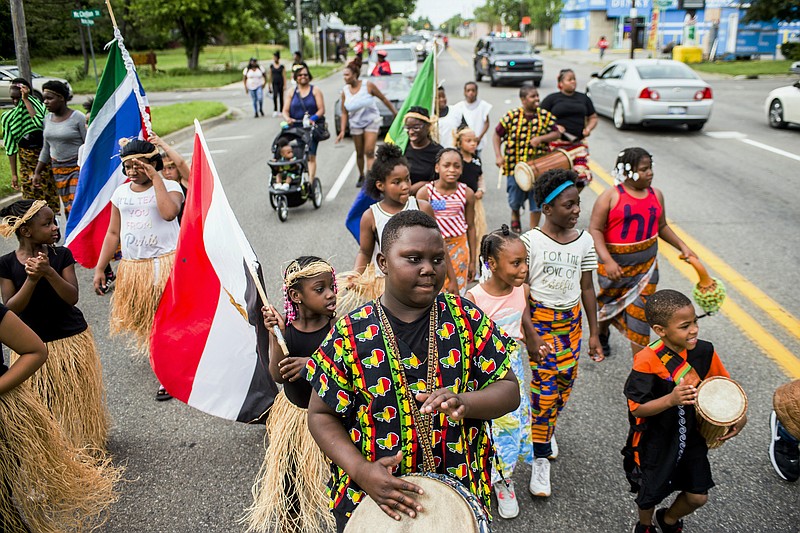 FILE - In this June 19, 2018, file photo, Zebiyan Fields, 11, at center, drums alongside more than 20 kids at the front of the Juneteenth parade in Flint, Mich. Juneteenth celebration started with the freed slaves of Galveston, Texas. Although the Emancipation Proclamation freed the slaves in the South in 1863, it could not be enforced in many places until after the end of the Civil War in 1865.  (Jake May/The Flint Journal via AP, File)