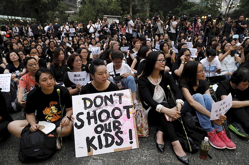 Hundreds of mothers protest against the amendments to the extradition law after Wednesday's violent protest in Hong Kong on Friday, June 14, 2019. Calm appeared to have returned to Hong Kong after days of protests by students and human rights activists opposed to a bill that would allow suspects to be tried in mainland Chinese courts. (AP Photo/Vincent Yu)