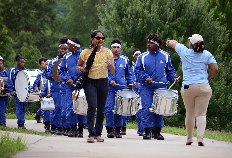 Planning Comittee co-chairs Maggie George, left, and Wyndi Chambers lead the Boys & Girls Club drumline Saturday June 15, 2019, during the 18th annual Juneteenth Heritage Festival at Ellis Porter Park. The drumline recently won first place in the St. Louis Battle of the Bands and were recognized for their achievements during the event. 
