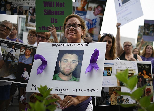 Christine Gagnon of Southington, Conn., protests Aug. 17, 2018, with other family and friends who have lost loved ones to OxyContin and opioid overdoses in Stamford, Conn. Gagnon lost her son Michael 13 months earlier. 