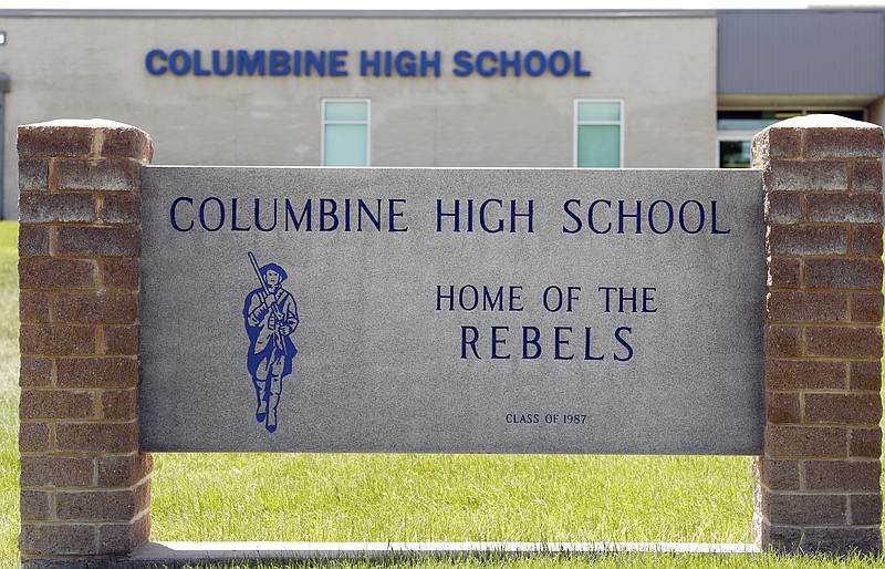 Signs outside Columbine High School are photographed, Thursday, June 13, 2019, in Littleton, Colo. The school district is considering the demolition of Columbine, the scene of a mass assault more than 20 years ago, and rebuilding the current school. (AP Photo/David Zalubowski)