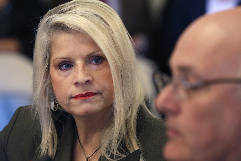 FILE - In this Wednesday, Jan. 28, 2015, file photo, Sen. Linda Collins-Smith, R-Pocahontas, listens to testimony at a meeting of the Senate Committee on Public Health, Welfare and Labor at the Arkansas state Capitol in Little Rock, Ark. Authorities on Friday, June 14, 2019, said they've arrested an Arkansas woman in connection with the killing of former state Sen. Linda Collins-Smith, who was found dead outside her own home, on June 4. (AP Photo/Danny Johnston, File)
