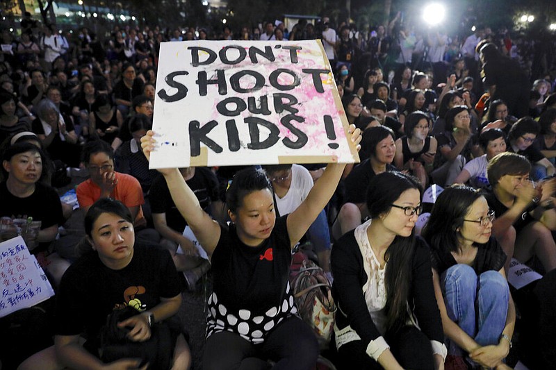 Hundreds of mothers protest against the amendments to the extradition law in Hong Kong on Friday, June 14, 2019. Calm appeared to have returned to Hong Kong after days of protests by students and human rights activists opposed to a bill that would allow suspects to be tried in mainland Chinese courts. (AP Photo/Vincent Yu)