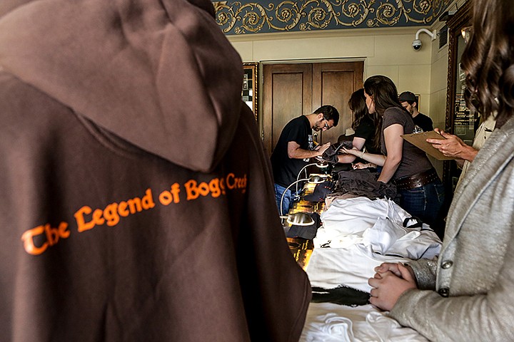 Community members purchase "The Legend of Boggy Creek" items before the premiere of the remastered movie at the Perot Theatre on Friday, June 14, 2019, in Texarkana, Texas. The movie premiered at 7 p.m. Friday at the Perot remastered in 4K so modern audiences could experience the cult classic from the 1970s. Staff photo by Hunt Mercier 