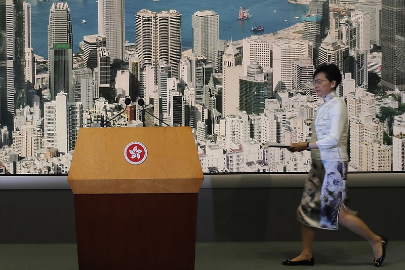 Hong Kong's Chief Executive Carrie Lam arrives at a press conference in Hong Kong Saturday, June 15, 2019. Lam said she will suspend a proposed extradition bill indefinitely in response to widespread public unhappiness over the measure, which would enable authorities to send some suspects to stand trial in mainland courts. (AP Photo/Kin Cheung)