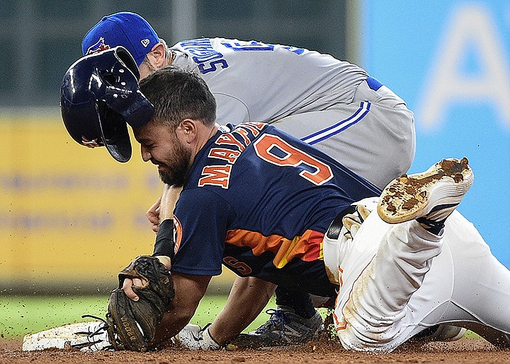 Houston Astros' Jack Mayfield (9) slides safely into second for a double, beating the tag of Toronto Blue Jays second baseman Eric Sogard during the sixth inning of a baseball game, Saturday, June 15, 2019, in Houston. (AP Photo/Eric Christian Smith)