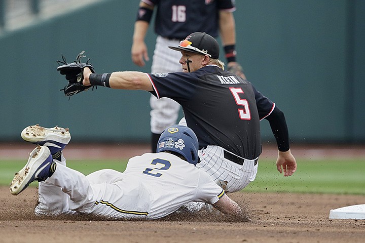 Michigan's Jack Blomgren (2) steals second base against Texas Tech second baseman Brian Klein (5) in the second inning of an NCAA College World Series baseball game in Omaha, Neb., Saturday, June 15, 2019. (AP Photo/Nati Harnik)