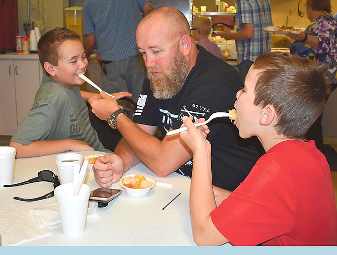 Bill Plate, center, horses around with sons Canaan, 11, left, and Maddox, 10, during Sunday's American Legion Post 5 breakfast. The two boys spent some quality time with their father over the weekend.