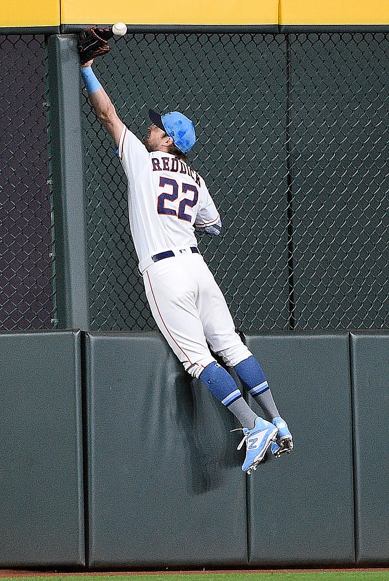 Houston Astros right fielder Josh Reddick misses the catch of Toronto Blue Jays' Eric Sogard's triple during the first inning Sunday, June 16, 2019, in Houston.