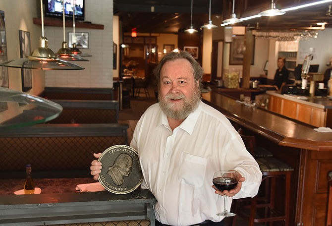 Rob Agee poses in the bar of Madison's Cafe. His business recently received the Landmark designation. Agee has been active over the years, involved in several projects to renew interest in the downtown area and in Jefferson City in general.