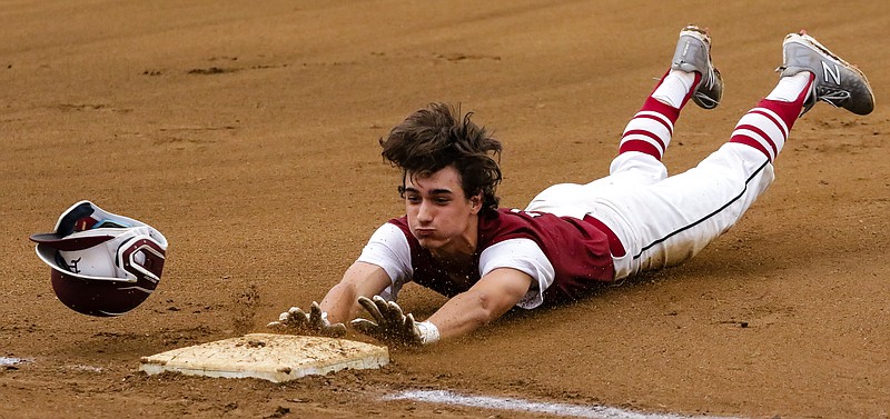 Texarkana Razorbacks' Gage Harris slides into third base after hitting the ball into center field against the Texarkana Bulldogs on Sunday, June 16, 2019, at the championship game for the Phil Sandoval Memorial Tournament at George Dobson field in Texarkana, Texas.