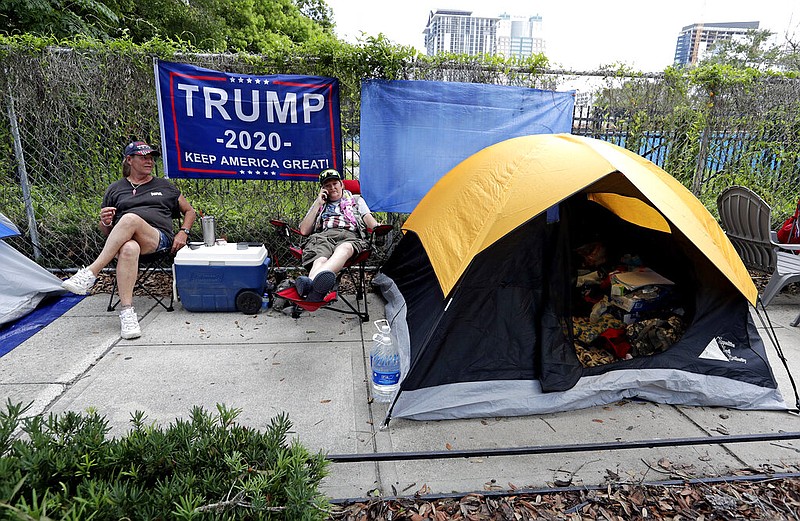Anna Connelly, left, and Jeanna Gullett supporters of President Donald Trump, make camp Monday, June 17, 2019, in Orlando, Fla. as they wait to attend a rally for the president on Tuesday evening. 