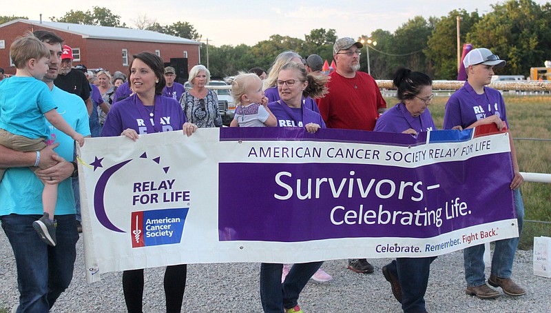 Cancer survivors begin their lap around the Moniteau County Fairgrounds track June 14, 2019, at the Moniteau County Relay for Life.