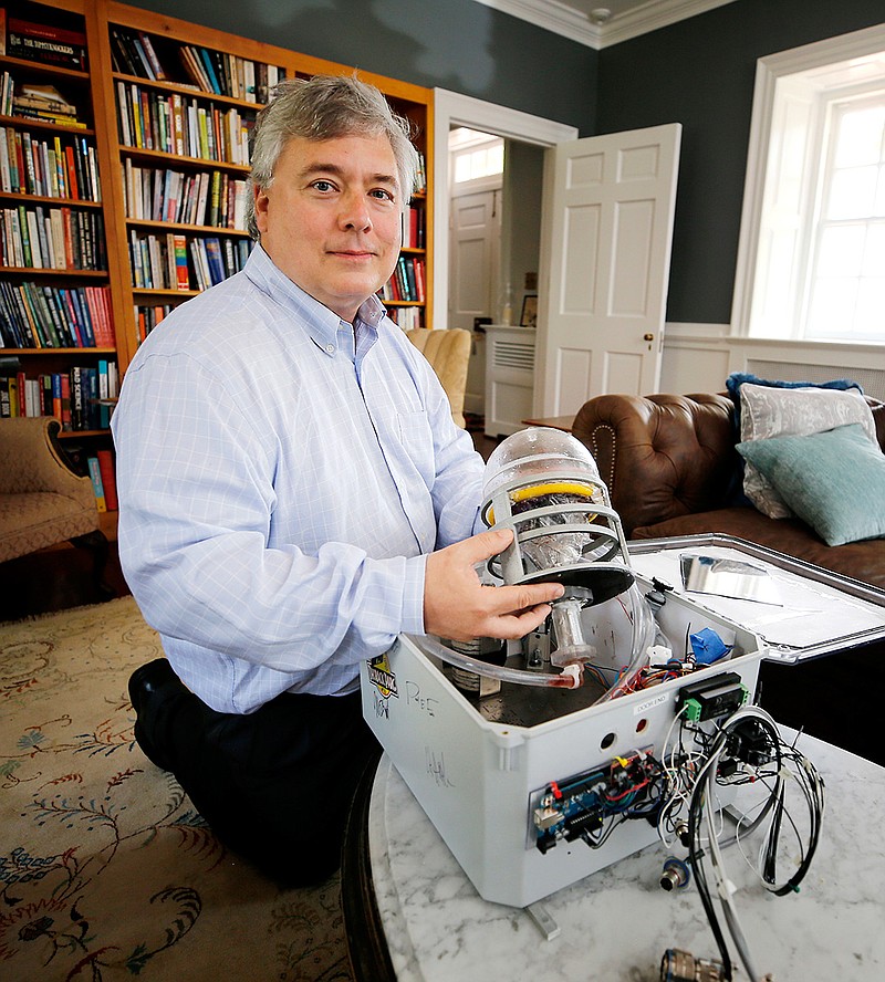 In this June 10, 2019 photo, Dr. Marsh Cuttino, who founded Orbital Medicine, which develops medical devices for space travel, shows off the Evolved Medical Microgravity Suction Device which is able to collect blood in microgravity for procedures such as collapsed lungs, in Richmond, Va. (Joe Mahoney/Richmond Times-Dispatch via AP)