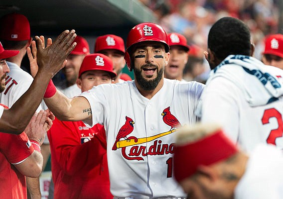 Matt Carpenter is congratulated by his Cardinals teammates in the dugout after hitting a home run in the third inning of Monday night's game against the Marlins at Busch Stadium.