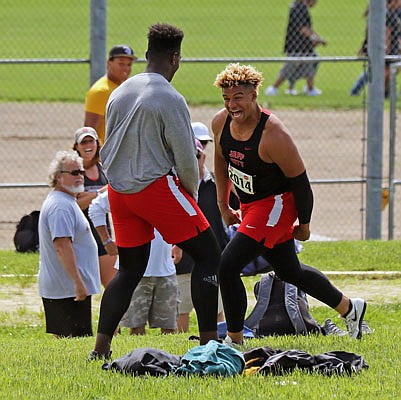 Devin Roberson celebrates with Jefferson City teammate Corey Suttle during his run to the Class 5 state discus title last month in Columbia.