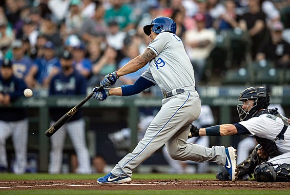 Cheslor Cuthbert of the Royals hits an RBI single off of Mariners starter Tayler Scott during the first inning of Monday night's game in Seattle.