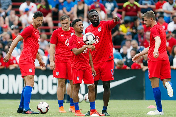 United States midfielder Duane Holmes (center) and forward Jozy Altidore (center right) talk during warmups before last Sunday's international friendly against Venezuela in Cincinnati.