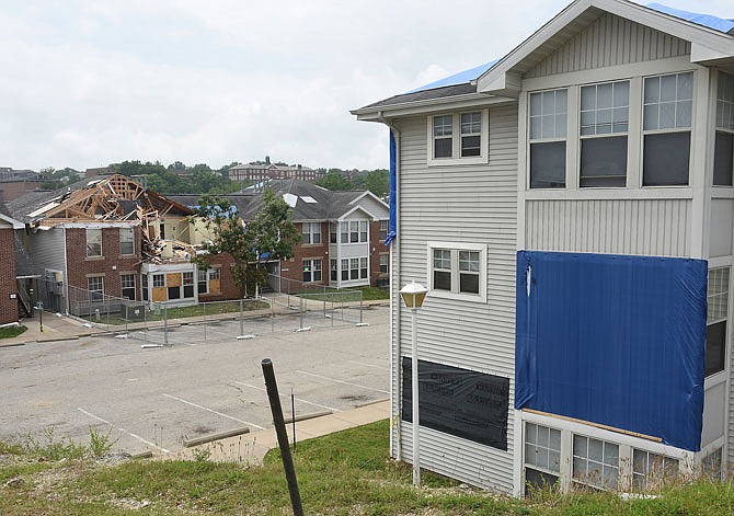 Officials from Jefferson City Housing Authority, which manages Capital City Apartments, said everyone was either back in their apartment or have found other places to stay. Most of the buildings suffered broken windows or damaged roofing and siding, while the one pictured in the background was evacuated immediately due to the significant damage it suffered.