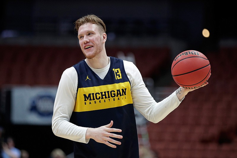 FILE - In this Wednesday, March 27, 2019 file photo, Michigan's Ignas Brazdeikis smiles while running through a drill during practice at the NCAA men's college basketball tournament in Anaheim, Calif. With only a few days remaining before the NBA draft, Iggy Brazdeikis enjoyed a reunion of sorts when he worked out for the Cleveland Cavaliers. That meant a chance to catch up with John Beilein. The NBA draft is on Thursday, June 20, 2019.