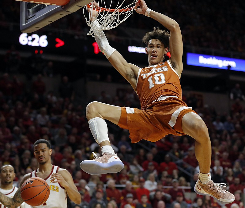  In this Feb. 2, 2019, file photo, Texas forward Jaxson Hayes (10) dunks the ball over Iowa State guard Nick Weiler-Babb, left, during the first half of an NCAA college basketball game, in Ames, Iowa. Hayes needed only a year at Texas to put himself at the front of the class of big men in the NBA draft coming Thursday, June 20, 2019. (AP Photo/Charlie Neibergall, File)