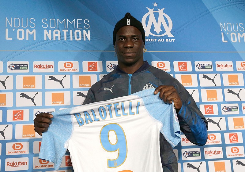 FILE - In this file photo dated Wednesday, Jan. 23, 2019, Olympique Marseille's new player Mario Balotelli poses during a press conference, at the club's headquarters of La Commanderie, in Marseille, southern France. The French club Marseille, is out of European competition after a fifth-place finish in Ligue 1, despite an attack that includes Mario Balotelli, and now Marseille must pay UEFA 2 million euros ($2.24 million) for breaking financial fair play rules, according to a UEFA announcement Wednesday June 19, 2019. 