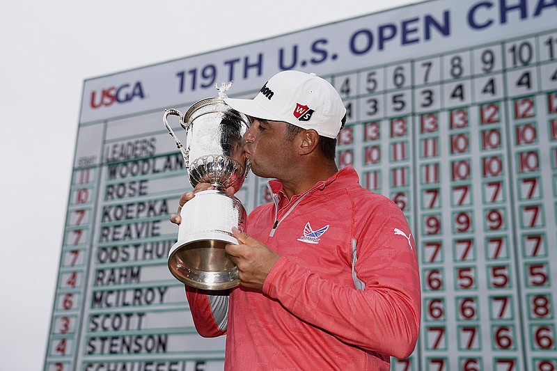 Gary Woodland posses with the trophy after winning the U.S. Open Championship golf tournament Sunday, June 16, 2019, in Pebble Beach, Calif. (AP Photo/Carolyn Kaster)